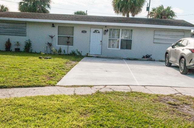 single story home with a front lawn