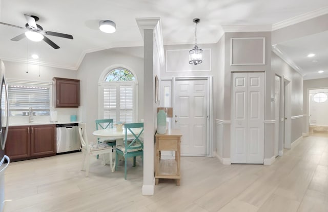 dining area featuring vaulted ceiling, sink, and ceiling fan with notable chandelier