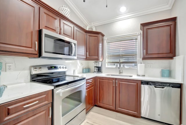 kitchen with backsplash, sink, ornamental molding, and appliances with stainless steel finishes