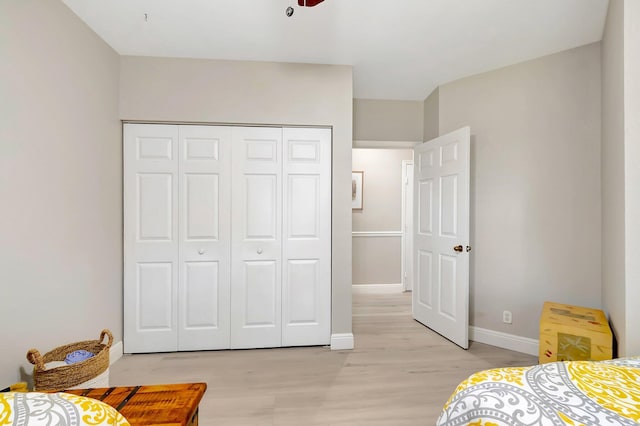 bedroom featuring light hardwood / wood-style floors and a closet