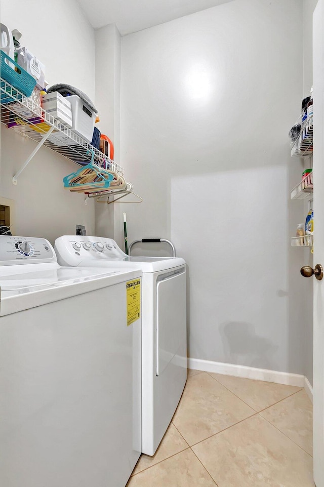 laundry area featuring independent washer and dryer and light tile patterned floors