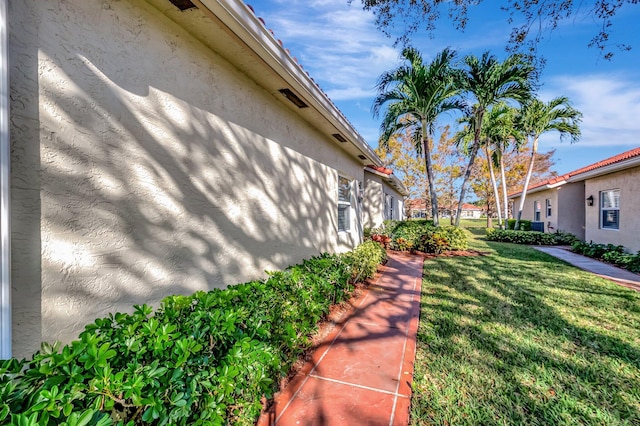 view of side of property with a lawn