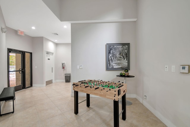 recreation room with light tile patterned floors and french doors