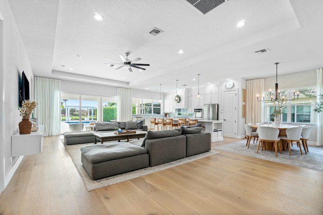 living room with built in desk and light hardwood / wood-style flooring