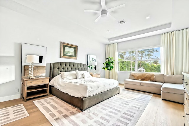 bedroom with light hardwood / wood-style flooring and ceiling fan