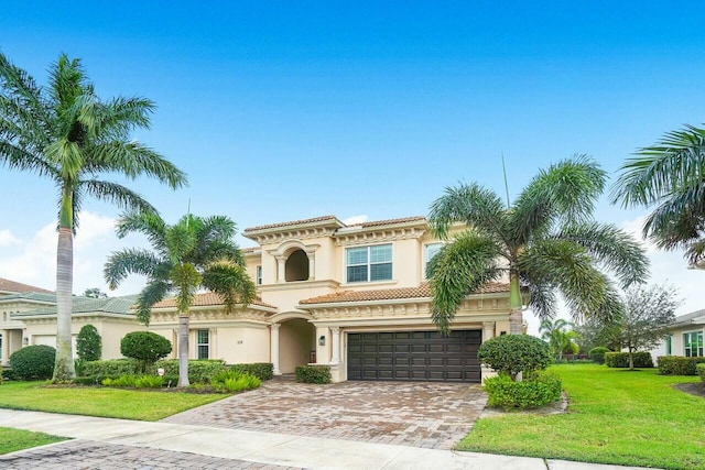 view of front of home with a front yard and a garage