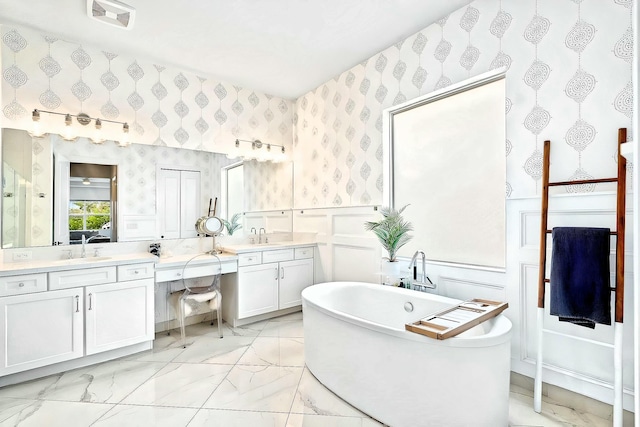 bathroom with a washtub and vanity