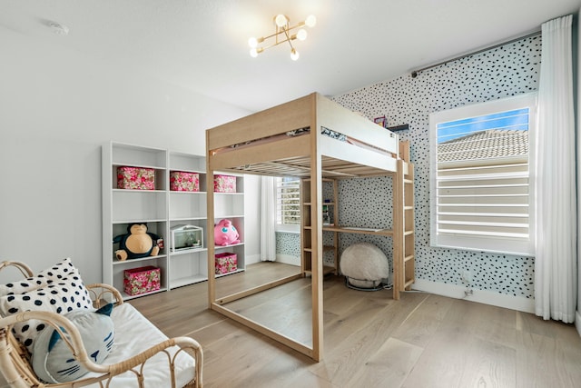 bedroom featuring hardwood / wood-style flooring and an inviting chandelier