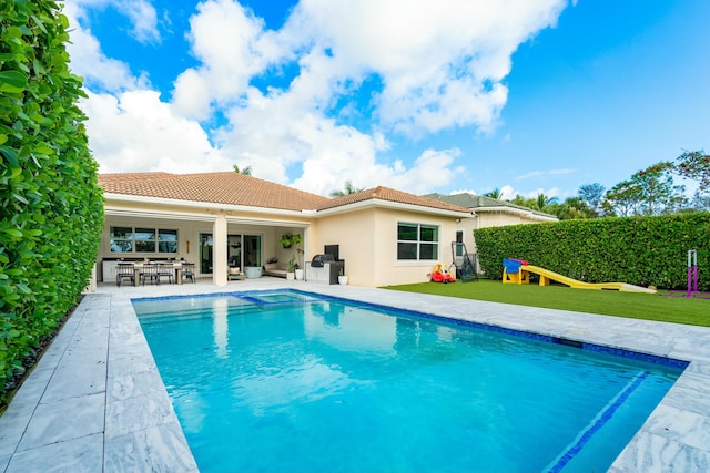 view of pool with a patio and a fire pit