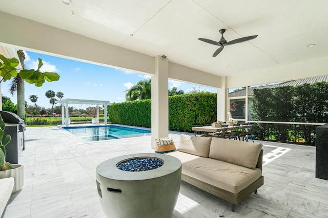 view of swimming pool with a fire pit and a patio area