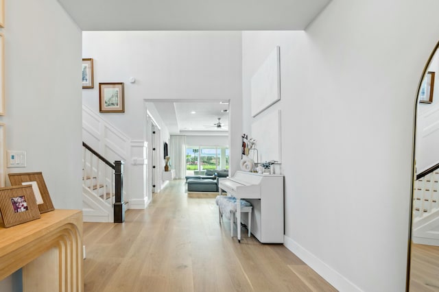 foyer entrance featuring ceiling fan and light hardwood / wood-style floors