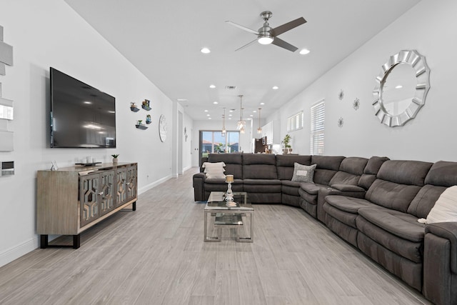 living room featuring light hardwood / wood-style floors and ceiling fan