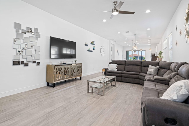 living room with ceiling fan and light hardwood / wood-style floors