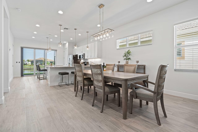 dining area with light hardwood / wood-style floors