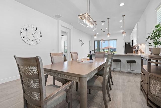 dining room featuring a chandelier and light hardwood / wood-style floors