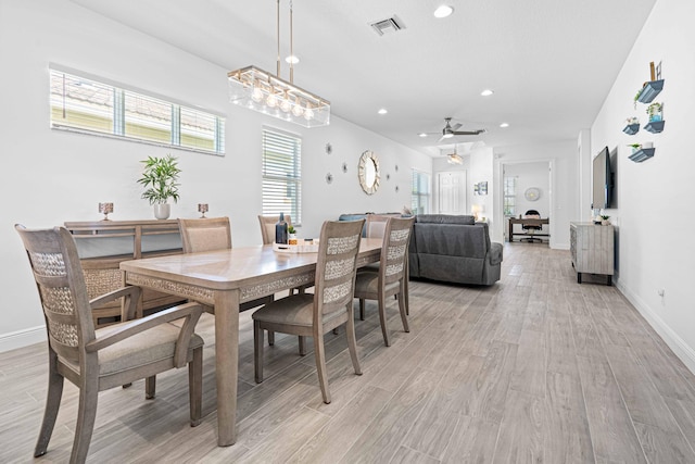 dining area with ceiling fan and light hardwood / wood-style flooring