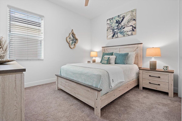 bedroom featuring ceiling fan and light colored carpet