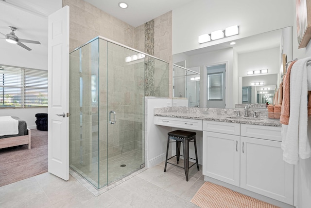 bathroom with ceiling fan, vanity, and walk in shower