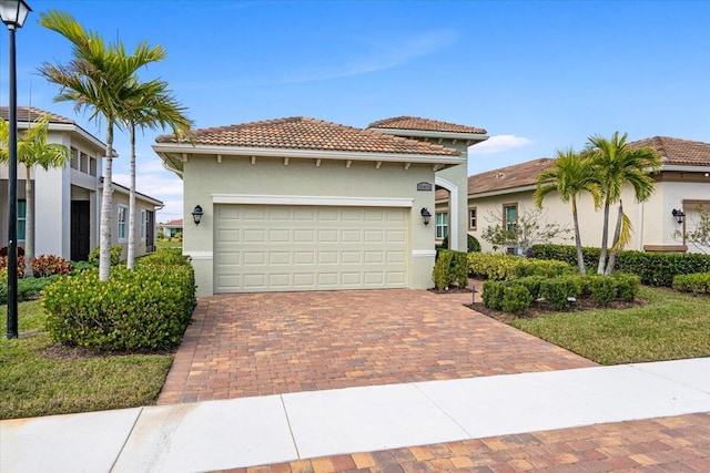 mediterranean / spanish-style home with a front lawn and a garage