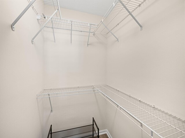 laundry area featuring laundry area and stacked washing maching and dryer