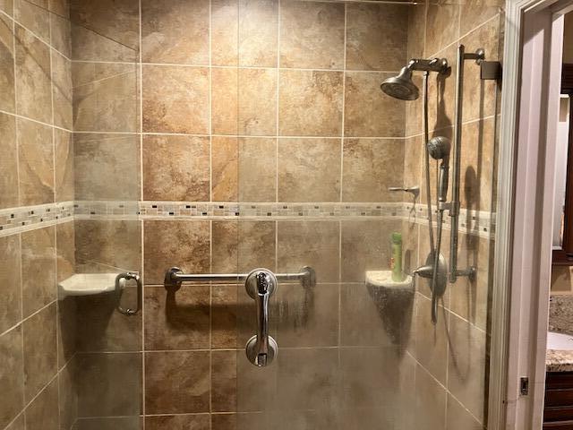 bathroom with a shower with shower door