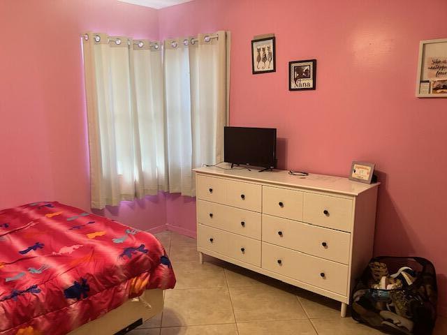 bedroom featuring light tile patterned floors