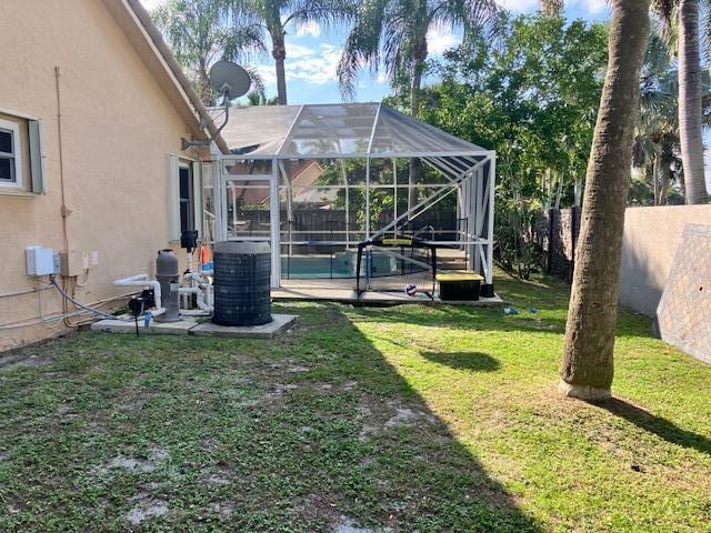 view of yard featuring glass enclosure