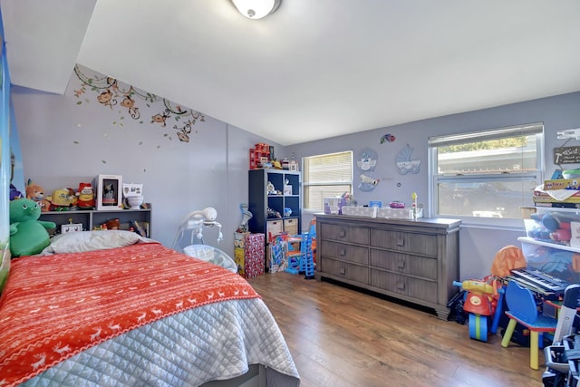 bedroom with hardwood / wood-style floors and lofted ceiling