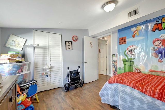 bedroom featuring hardwood / wood-style floors and vaulted ceiling