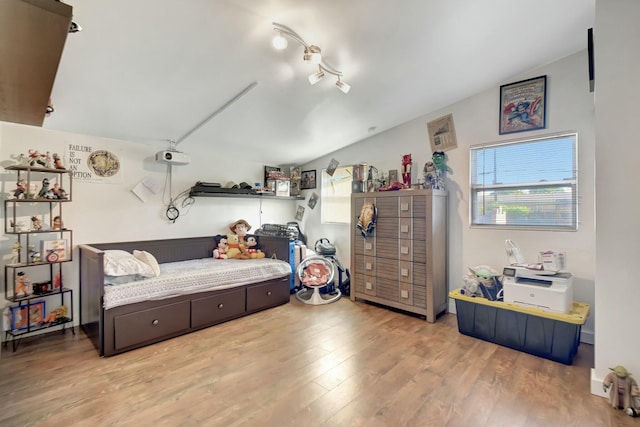 bedroom featuring light hardwood / wood-style flooring and lofted ceiling