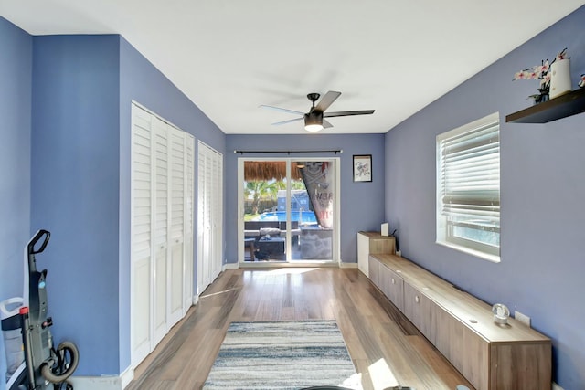 living area featuring light hardwood / wood-style floors and ceiling fan