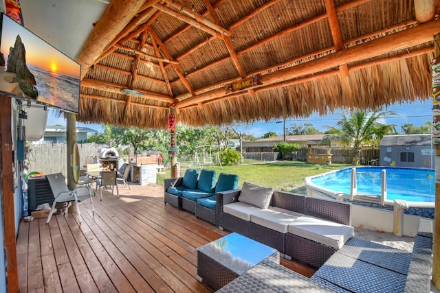 deck with a yard, an outdoor living space, a fenced in pool, and a gazebo