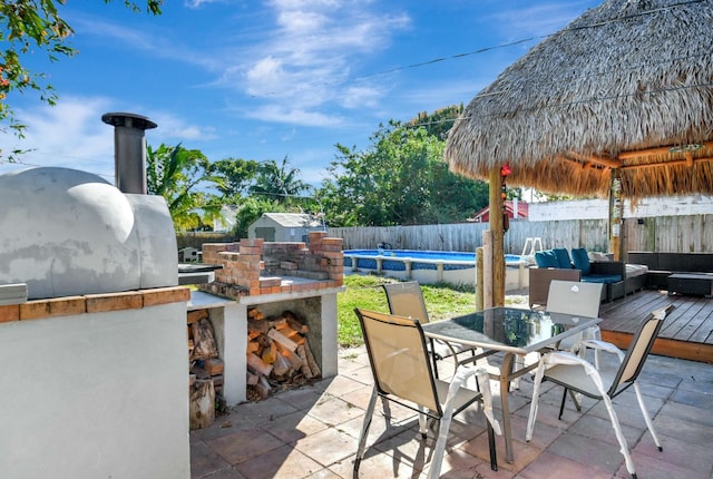 view of patio / terrace featuring an outdoor living space with a fireplace and a swimming pool side deck