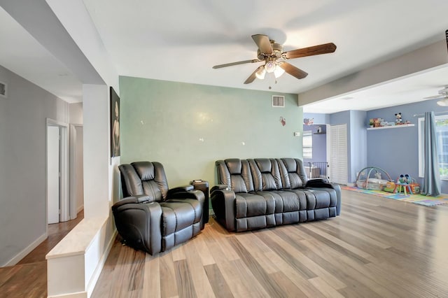 living room with hardwood / wood-style flooring and ceiling fan