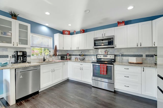 kitchen featuring white cabinets, sink, and appliances with stainless steel finishes