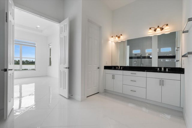 bathroom featuring tile patterned floors, vanity, and walk in shower