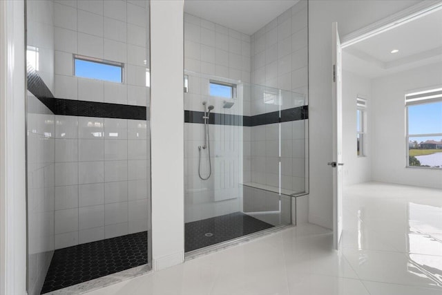 bathroom featuring tile patterned flooring and tiled shower