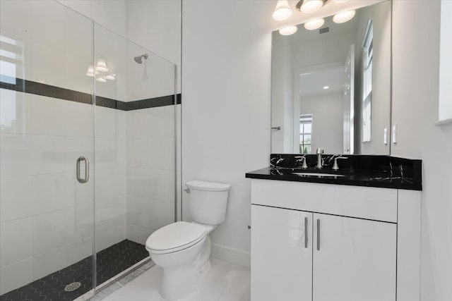 bathroom featuring tile patterned floors, vanity, toilet, and an enclosed shower