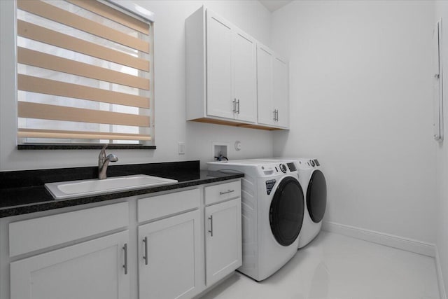 clothes washing area with cabinets, light tile patterned floors, sink, and washing machine and dryer