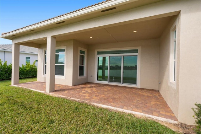 back of house featuring a patio area and a yard