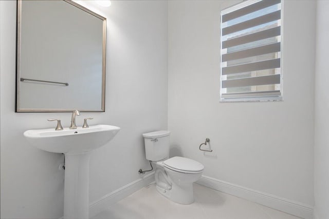 bathroom with tile patterned flooring and toilet