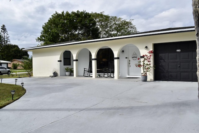 exterior space with covered porch and a garage