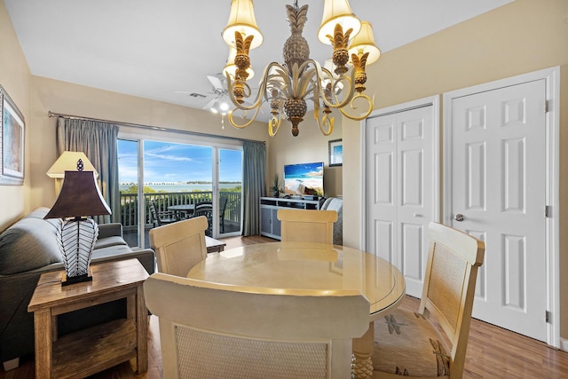 dining room featuring an inviting chandelier, visible vents, and wood finished floors