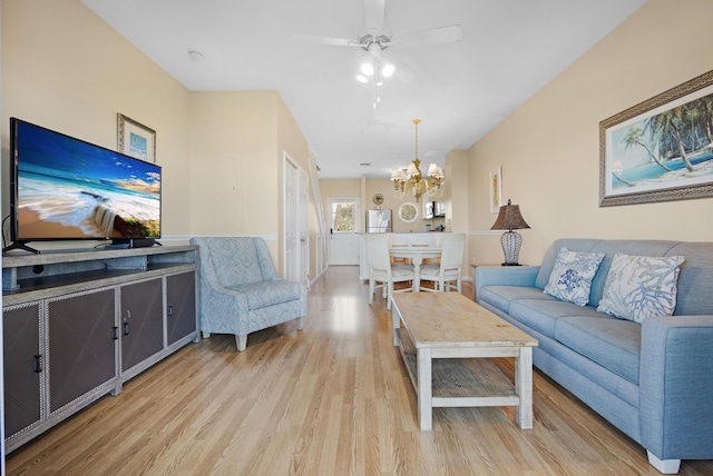 living room featuring light wood-type flooring and ceiling fan with notable chandelier