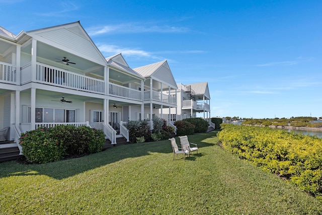 view of property's community featuring a water view and a yard