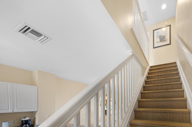 stairs featuring recessed lighting and visible vents