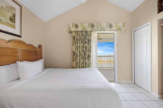 bedroom featuring access to outside, baseboards, vaulted ceiling, and light tile patterned flooring