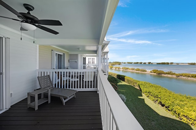 balcony with a water view and ceiling fan