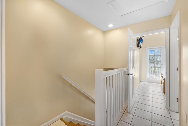 corridor with recessed lighting, attic access, an upstairs landing, baseboards, and tile patterned floors