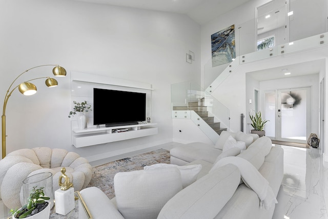 living room with french doors and high vaulted ceiling